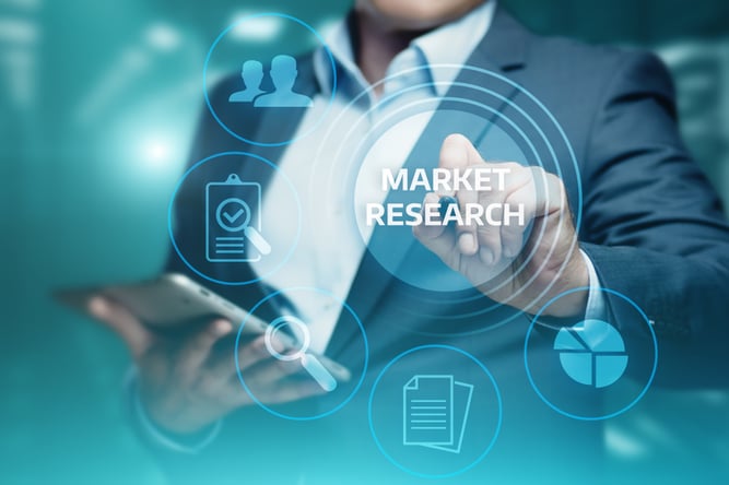 Man holding mobile device with translucent market research icon in front