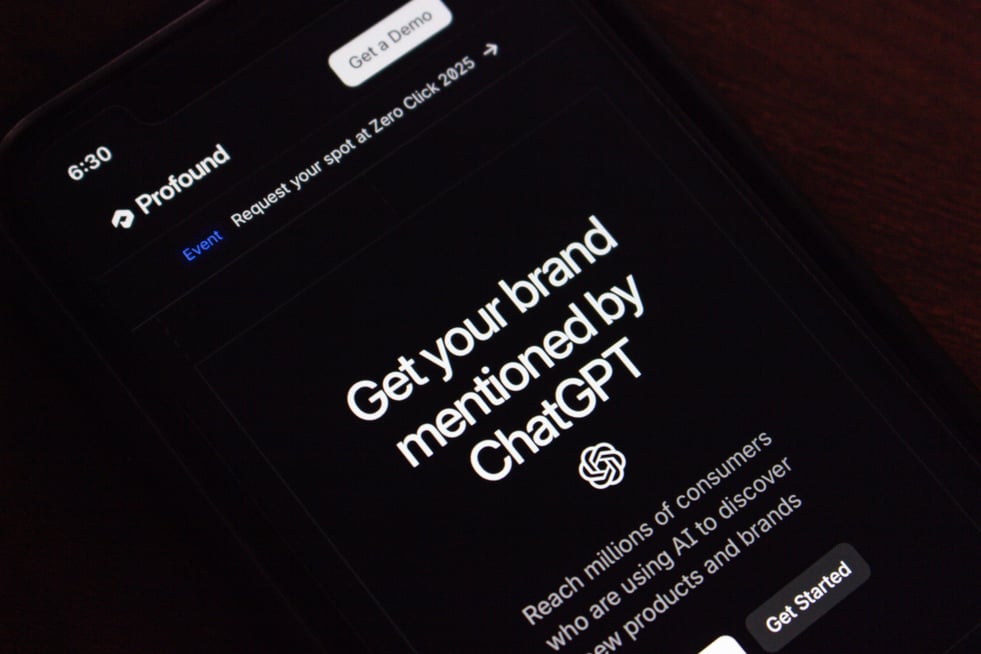 Phone screen that reads "Get your brand mentioned by ChatGPT," promoting answer engine optimization