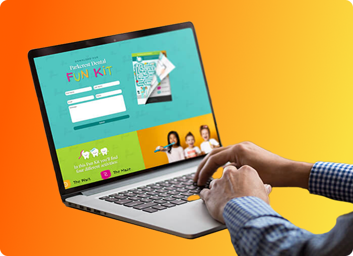 A person types on a laptop displaying a colorful website titled Fun Kit with a form, a maze, and images of smiling children, against a vibrant orange-yellow gradient background.